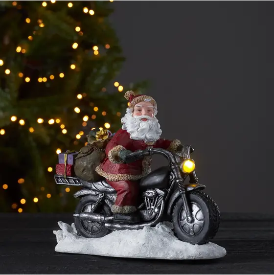 Tomte på motorcykel med lysande lampa (batteri)
